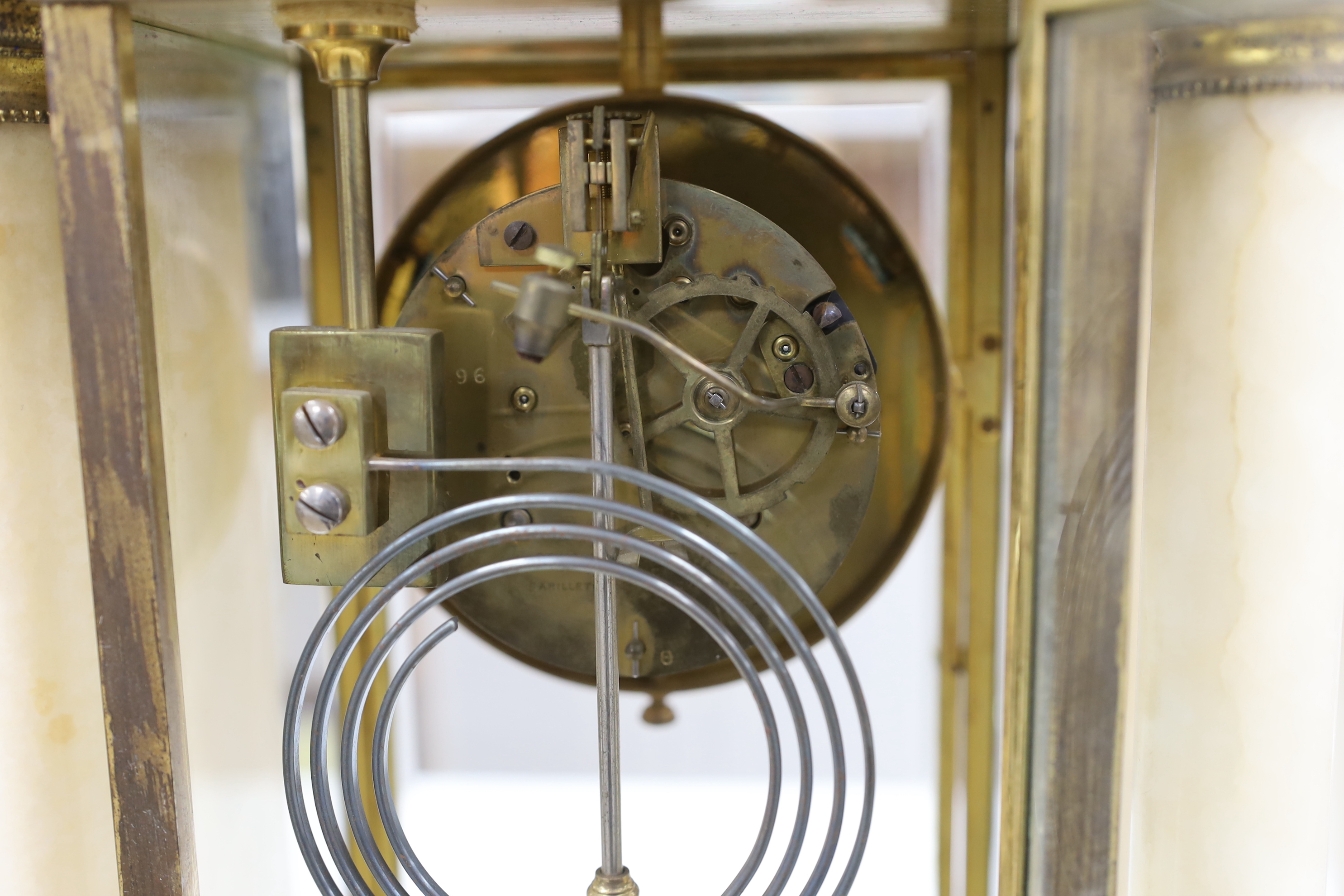 An early 20th century French four glass portico clock garniture with mercury pendulum, 50cm